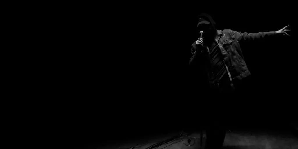 James Laurent performing live on a dark stage